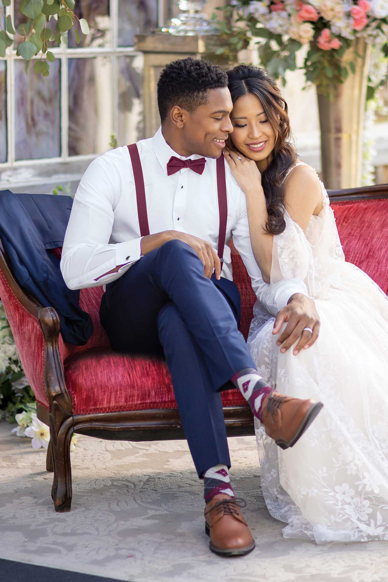 A bride and groom, elegantly dressed in Michael Kors Navy Sterling suits.