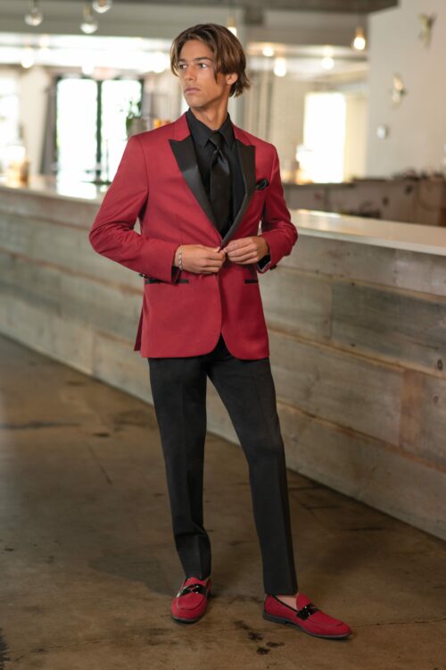 A man in a White/Silver Paisley Aries tuxedo posing for a picture.