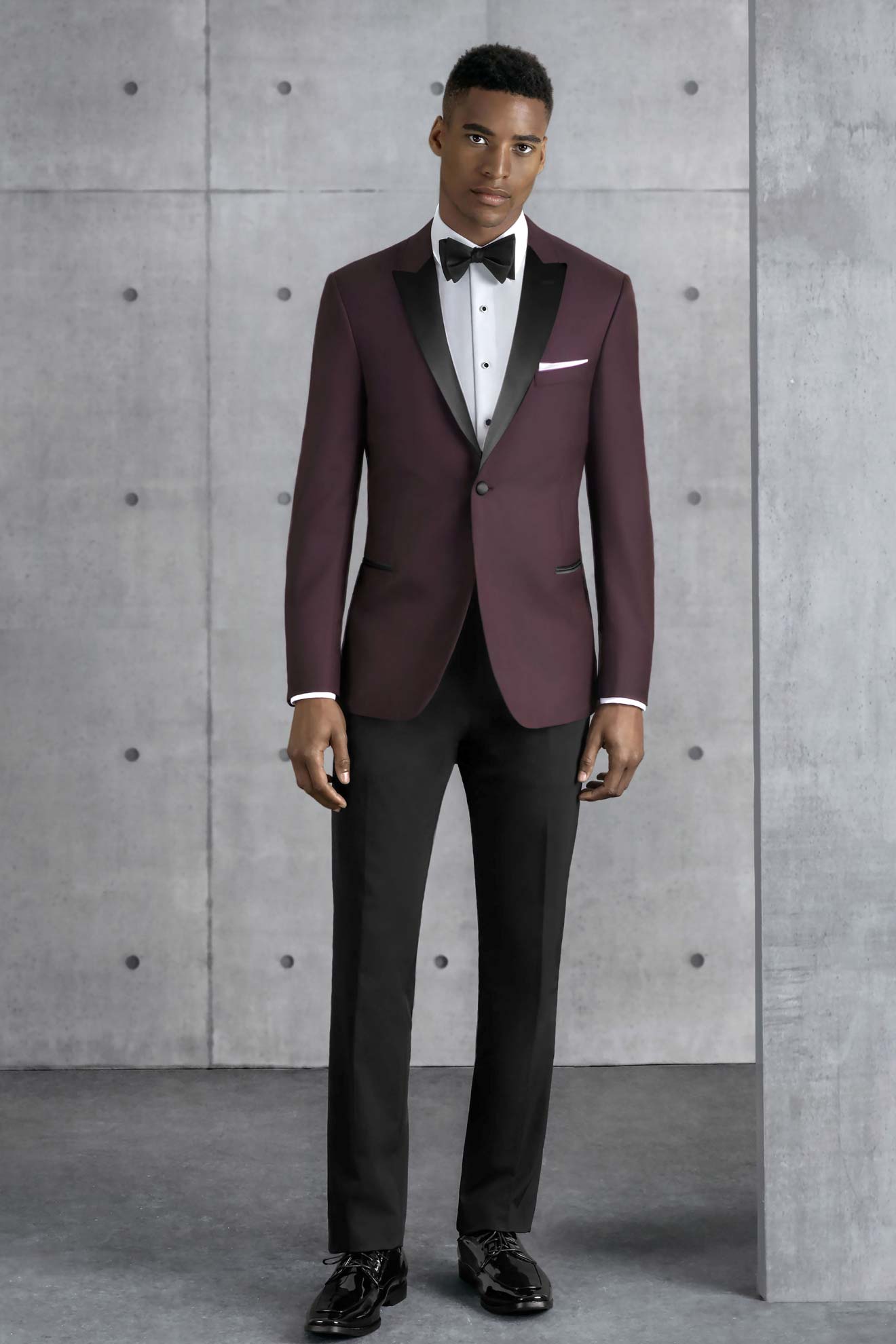 A man wearing an Allure Charcoal suit rental.
